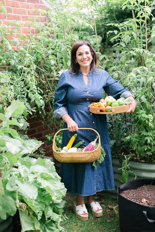 In the garden with the harvest basket. Vertical.