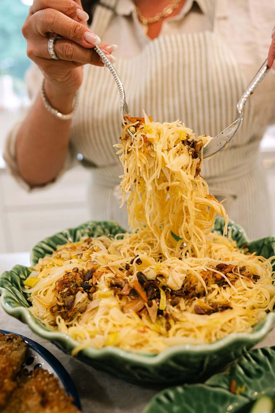 Pasta lifted from a green cabbage-leaf dish